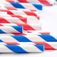 Multi-colored paper straws for drinks close-up on a white background. - PhotoDune Item for Sale