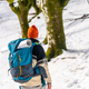 Hiker with backpack on his back walking on trekking on the snow, winter adventures, nature activity - PhotoDune Item for Sale