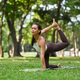 Beautiful woman practices yoga asana dhanurasana - bow pose in a
