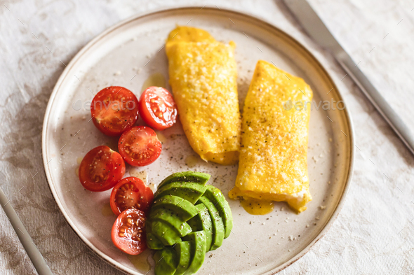 French omelette with tomatoes and avocado. - Stock Photo - Images