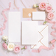 Cards and envelope between pink roses and pink silk ribbons on marble top view, wedding mockup - PhotoDune Item for Sale