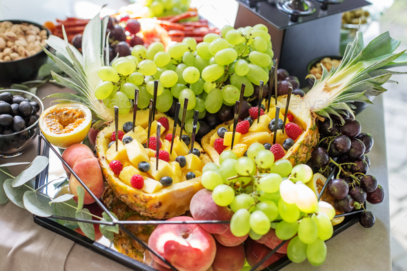 catering buffet table. Lots of tasty fruits and berries. - Stock Photo - Images