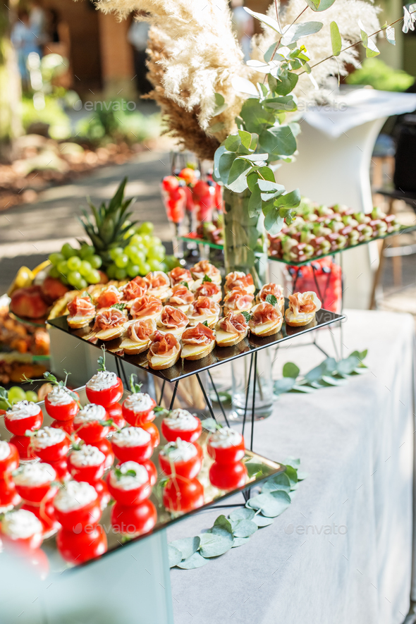 Large assortment of appetizers for an event in restaurant. Glass food stand - Stock Photo - Images