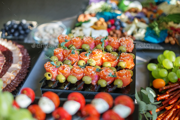 Set of appetizers with red fish olives and sesame. catering buffet table with different appetizers. - Stock Photo - Images