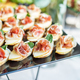 catering buffet table with snacks and appetizers. Set of canapés with jamon, bruschetta and cheese - PhotoDune Item for Sale