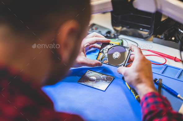 IT engineer technician repairing computer in electronics service shop - Stock Photo - Images