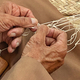 Diverse senior traditional fisherman artisan makes a fishing net by hand - PhotoDune Item for Sale