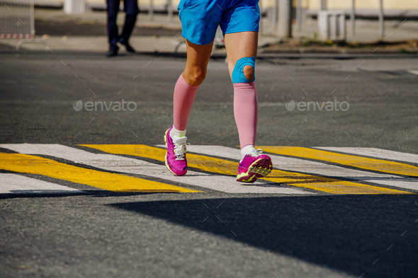 legs girl runner in compression socks running marathon