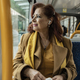 mature woman listens to music with headphones while traveling in public transport on the way to work - PhotoDune Item for Sale