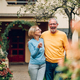 Senior couple holding keys and standing outside their new home - PhotoDune Item for Sale