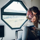 Man is embracing his girlfriend while she is reading a book at home - PhotoDune Item for Sale