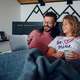 Romantic couple lying in the bed at home in the morning and using laptop - PhotoDune Item for Sale