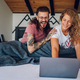 Romantic couple lying in the bed at home in the morning and using laptop - PhotoDune Item for Sale