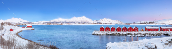 Breathtaking scenery wit traditional red wooden houses on the shore of Offersoystraumen fjord. - Stock Photo - Images