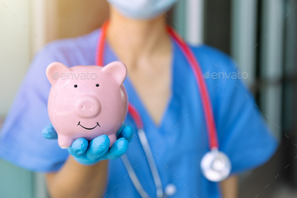 medical staff hand showing piggy bank smile saving money for healthcare health insurance concept
