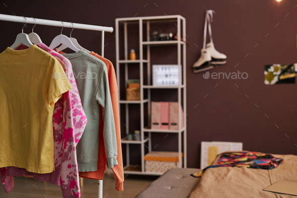 Open closet clothes on hangers in teenage girls room - Stock Photo - Images