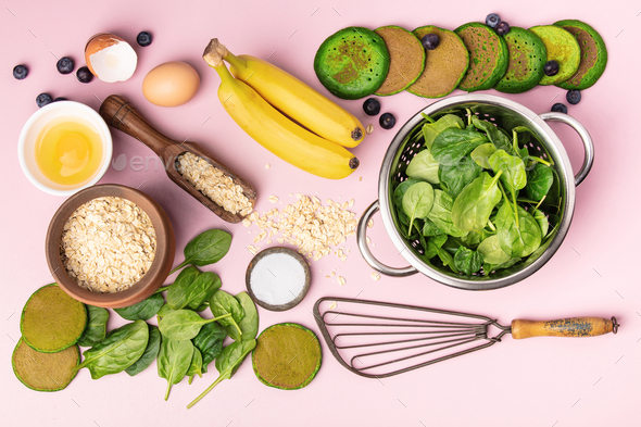 Spinach pancakes and ingredients on pink background, flat lay - Stock Photo - Images