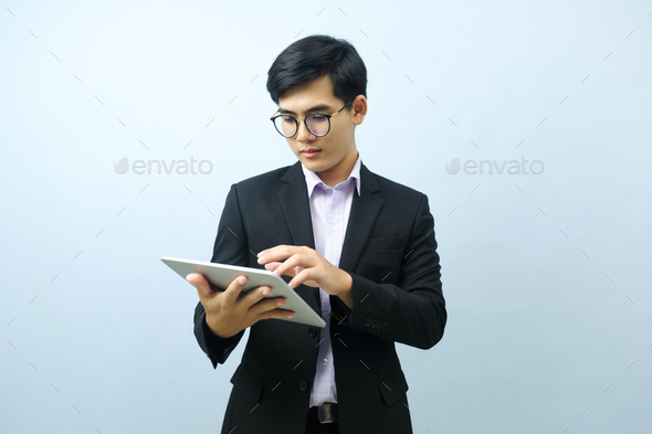 Portrait of businessman using tablet. - Stock Photo - Images