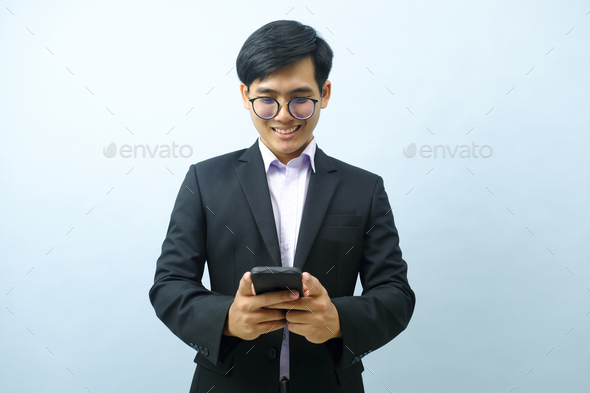 Portrait of businessman using smartphone. - Stock Photo - Images