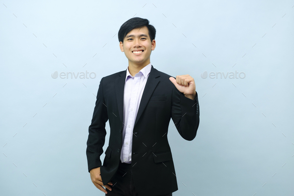 Portrait of businessman pointing thumb at himself. - Stock Photo - Images