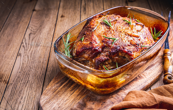 Roasted pork meat with potatoes, rosemary and beer sauce - Stock Photo - Images