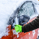 Teenager  cleans car after a snowfall, removing snow and scraping ice - PhotoDune Item for Sale