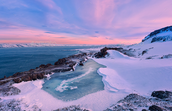 A small frozen lake and the Barents Sea coastline. Teriberka, Murmansk Region, Russia - Stock Photo - Images
