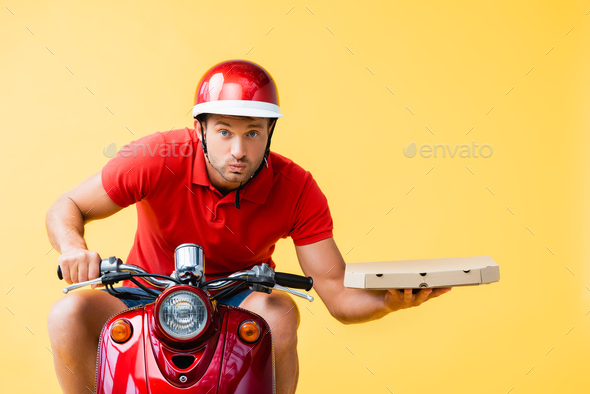 concentrated delivery man in helmet riding red scooter and holding ...