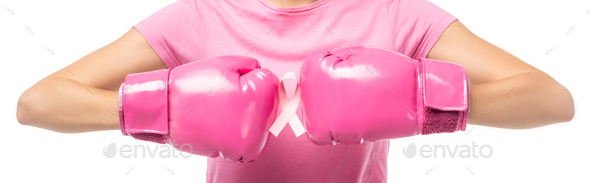 Panoramic shot of young woman in pink boxing gloves holding ribbon of breast cancer awareness