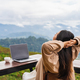 Young woman freelancer working online using laptop and enjoying the beautiful nature landscape - PhotoDune Item for Sale