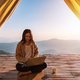 Young woman freelancer working online using laptop with mountain view at sunrise - PhotoDune Item for Sale