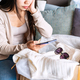 Dissatisfied young woman unpacking parcel at home received damaged and wrong online shopping order - PhotoDune Item for Sale