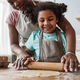Loving mother and daughter baking together at home and rolling dough - PhotoDune Item for Sale