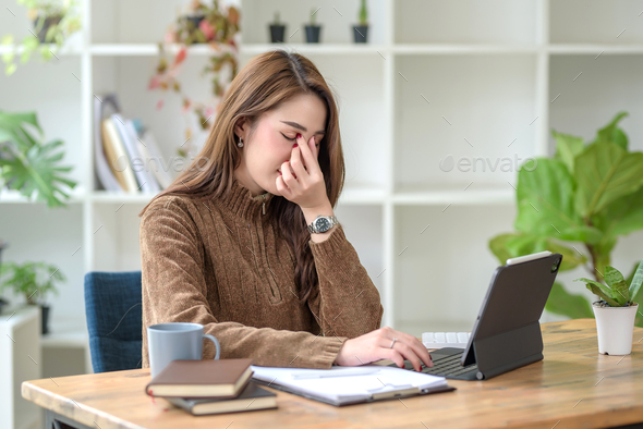 Young Asian woman overworked feels eye strain tension problem. Beautiful Asian businesswoman feeling