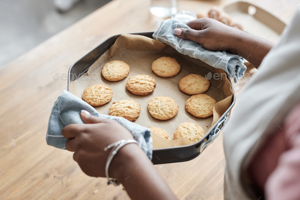 Little girl holding tray with homemade cookies close up - Stock Photo - Images