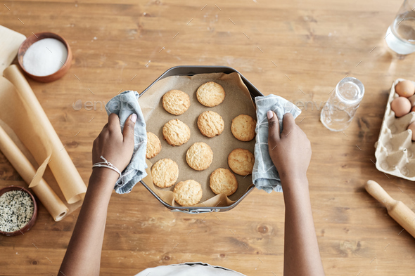 Little girl holding tray with homemade cookies top view - Stock Photo - Images