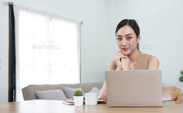 Portrait of Young woman using laptop computer at the office, Student girl working at home. Work or - Stock Photo - Images