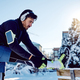 Male athlete stretching his leg while exercising in winter park. - PhotoDune Item for Sale