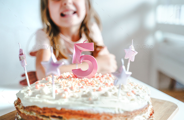 Big pink 5 number candle on homemade cake. Creative congratulations on five years for child girl.  - Stock Photo - Images