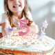 Big pink 5 number candle on homemade cake. Creative congratulations on five years for child girl.  - PhotoDune Item for Sale