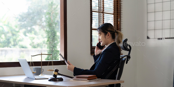 Attractive young lawyer in office Business woman and lawyers call phone in office. Law, legal - Stock Photo - Images