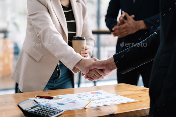 Business people shaking hands, finishing up meeting, business etiquette, congratulation, merger and - Stock Photo - Images