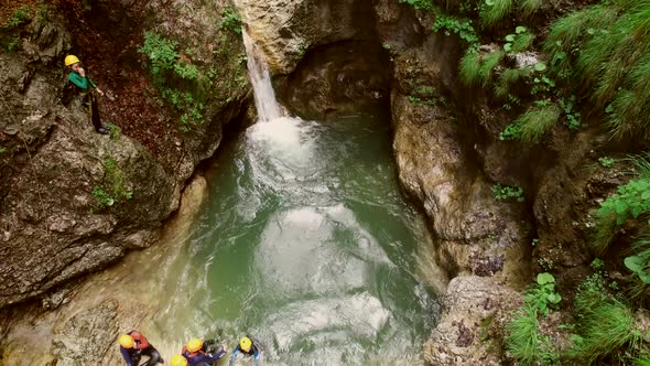 Aerial view of kid jumping into the water in Soca river, Slovenia alt