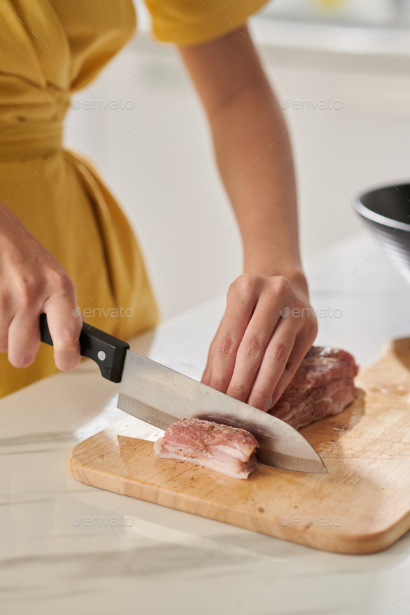 Woman Cutting Seasoned Pork - Stock Photo - Images