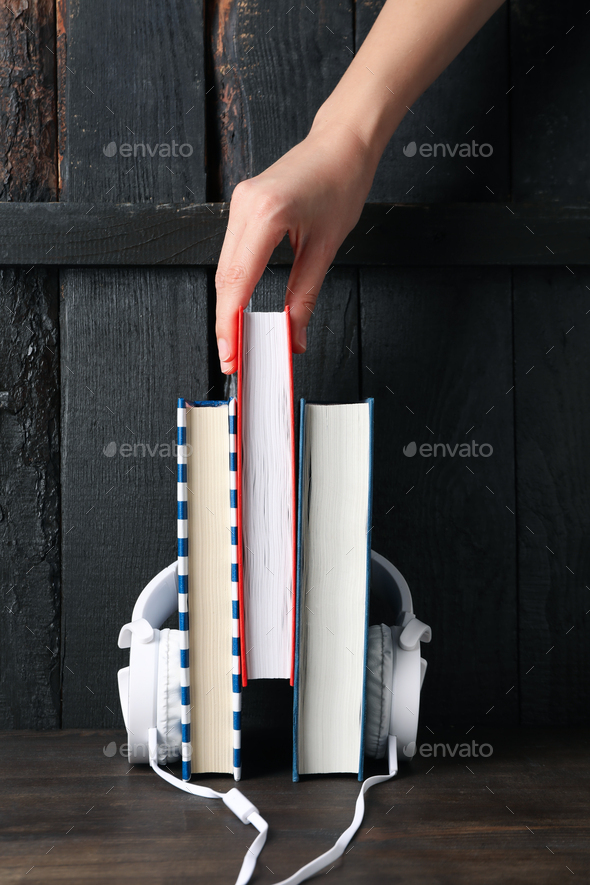 Concept of audiobook with books and headphones - Stock Photo - Images