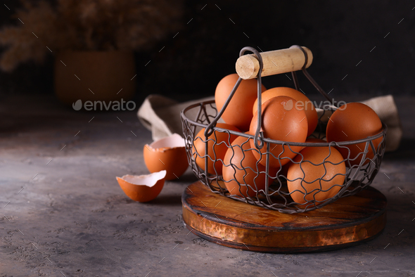 fresh organic eggs in a basket - Stock Photo - Images
