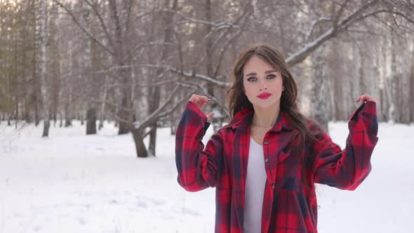 Charming Female with Long Hair Walking in Snowy Forest