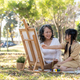 Happy and lovely Asian grandmother teaching her granddaughter to paint watercolors on canvas - PhotoDune Item for Sale