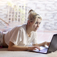 Serious woman working at home behind laptop in the morning - PhotoDune Item for Sale