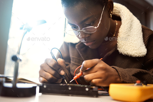 University student, engineering and electronics with black woman learning on electrical project. Ed